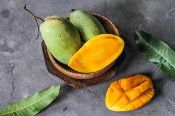 Photo of top view mango slice. Fresh green mango with green leaves. High vitamin C fruit. Green Fruit. Still life photography. Image