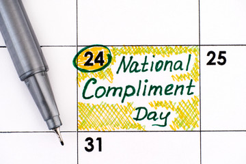 Reminder National Compliment Day in calendar with pen. - Powered by Adobe