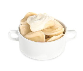 Pot with tasty dumplings on white background