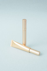 Different golden mascara on a pastel blue background, pattern. Collection of decorative mascara