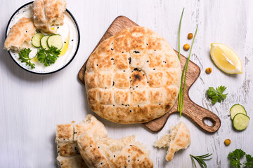 Flatbread, baked traditional oriental or indian bread with yoghurt dip - 315145915