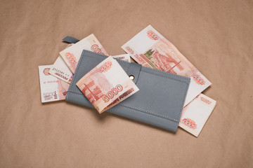 Russian money in a wallet studio image. Women's wallet with Russian rubles. Russian money bills in a gray wallet.