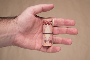 Male hand with russian money studio image. Man's hand holds Russian rubles. Male hand with money.