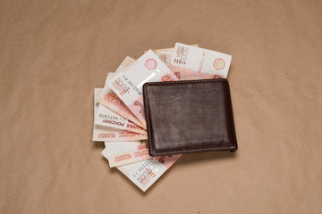 Wallet with Russian money. Studio image. Men's wallet with Russian rubles. Brown wallet with money.