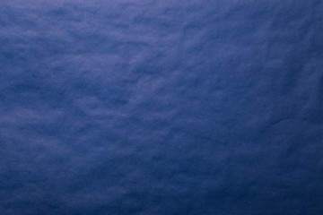 Background from blue paper. Crumpled paper texture. Background, texture of colored parchment paper.