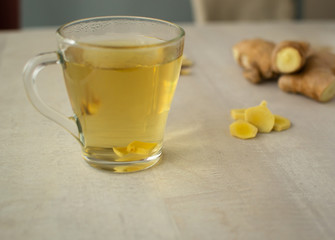 Fresh ginger tea on a light background. Ginger is suitable for cooking and preparing drinks. Close-up