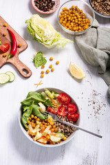Quinoa salad with chickpeas on white background, cooking ingredients for vegan diet lunch