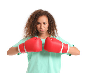 African-American woman in boxing gloves on white background. Concept of feminism