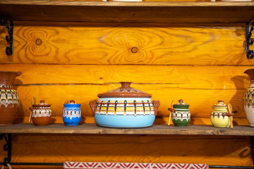 Old fashioned kitchen utensils in Russian folk style on wooden wall background