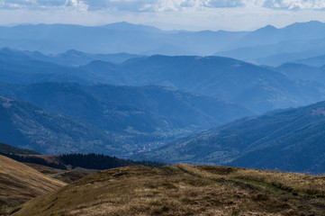 Colorful mountain landscape in the summer mountains. Large hills with blue sky.