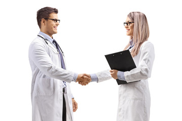 Male and female doctor shaking hands