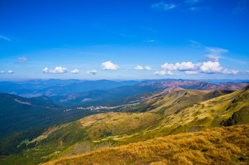 Fototapeta premium Colorful mountain landscape in the summer mountains. Large hills with blue sky.
