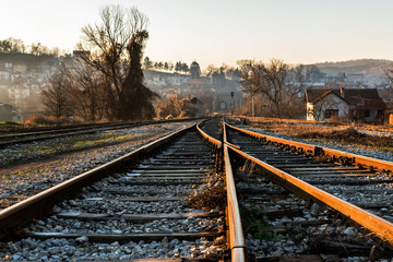 Old railway tracks in the autumn sunset