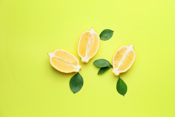 Ripe cut lemons on color background