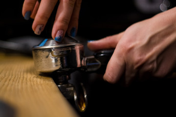 Fototapeta na wymiar Cappuccino preparation process in coffee shop. Profession barista. The invigorating coffee drink.