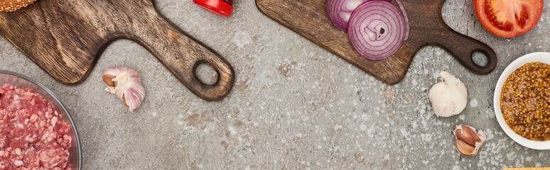 top view of fresh burger ingredients on grey concrete surface, panoramic shot