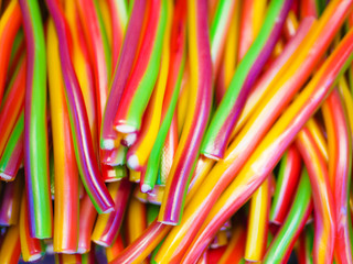 Sweets in the form of tubes. Multi-colored sweets. close-up. Children's sweets. The cause of childhood caries.