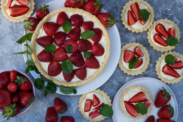 Tart with strawberries and whipped cream decorated with mint leaves