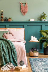 Stylish composition of bedroom interior with wooden bed, design furnitures, shelf, plants, decor...