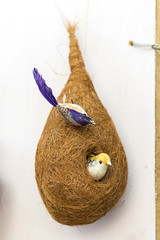 Fototapeta premium Indian traditional handmade bird with its nest and babies is displayed in a street shop for sale. Indian handicraft and art