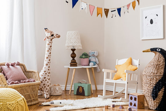 Stylish scandinavian interior of child room with mock up frame ,natural toys, hanging decoration, design furniture, plush animals, teddy bears and accessories.  Interior design of kid room. Template.