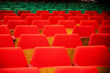 Abstract image with rows of red and green chairs