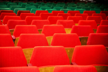Fototapeta premium Abstract image with rows of red and green chairs