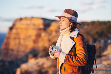 Young photographer with a retro camera in the National Park