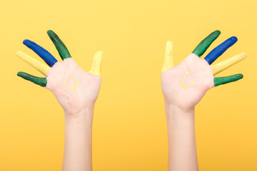 cropped view of woman showing colorful fingers isolated on yellow