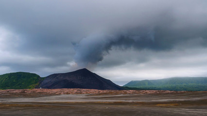 Thick dark grey smoke is coming out of the active volcano in Tanna, Vanuatu.