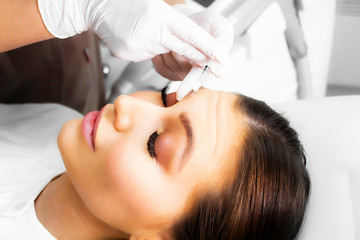 Fototapeta premium A beautiful woman lies on a skin rejuvenation procedure.