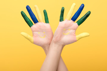 cropped view of woman with colorful fingers showing palms isolated on yellow