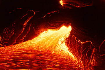 Detailed view of an active lava flow, hot magma emerges from a crack in the earth, the glowing lava appears in strong yellows and reds - Hawaii, Big Island, Kilauea volcano, Kalapana - obrazy, fototapety, plakaty