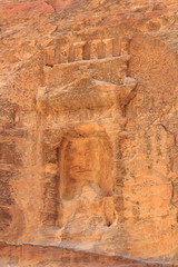 Fototapeta na wymiar Niche containing sacred stone Baetyl at gorge canyon Siq in ancient city of Petra in Jordan