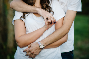 Young lovers pair, held of hands against the background of nature. view of couple on standing, women and man. upper half. Close Up.
