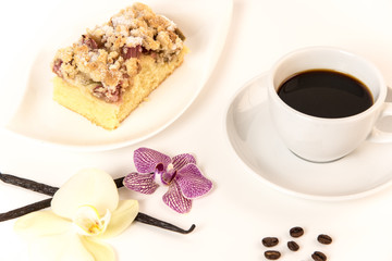 on a white background stands a cup of coffee and a plate with cake and orchids as decoration