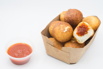 Fried Risotto Arancini stuffed with cheese, served with tomato sauce