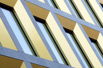 Geometric pattern from part of building facade. Modern architecture of commercial building walls and windows made of glass.
