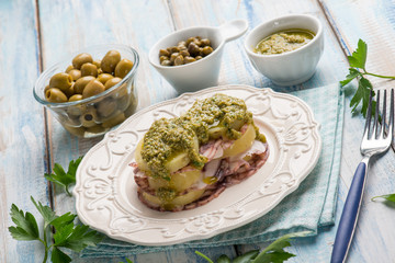 octopus carpaccio with potatoes green olives capers and pesto sauce