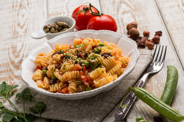 pasta with fresh tomatoes green peas capers and hazelnuts