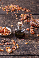 A bottle of myrrh essential oil with myrrh resin