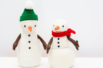 Toy snowman family on white background