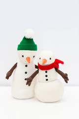 Toy snowman family on white background