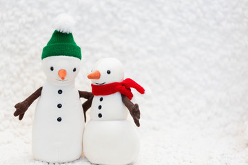 Toy snowman family on white background