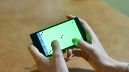 Womans hands using a Smart phone Touchscreen CHROMA KEY Close-up , Fingers make gestures touching and swiping the screen of a modern smartphone.