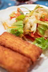 Potato croquette filled with cheese and herbs served with fresh green salad, tomatoes and pepper