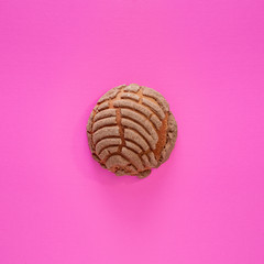 Concha Bread, Mexican Sweet Scone on Pink Surface.