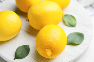 Fresh ripe lemons on white table