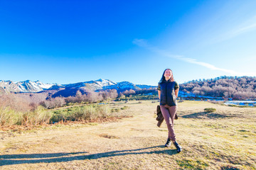 Smiling young woman in the mountain