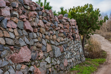 A stone granite high fence